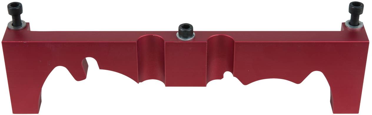 Red metal part with three screws, likely a tool or mounting component.