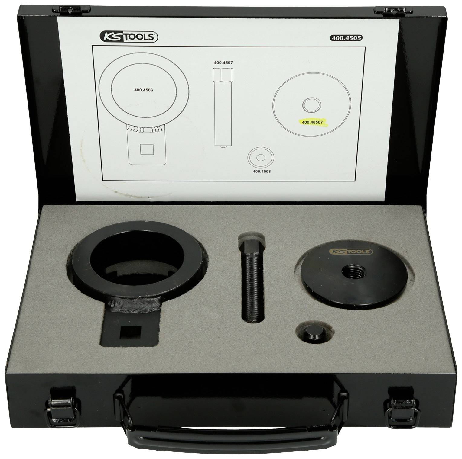 Black tool case with foam lining, contains two circular tools and a screw, diagram in lid explains.