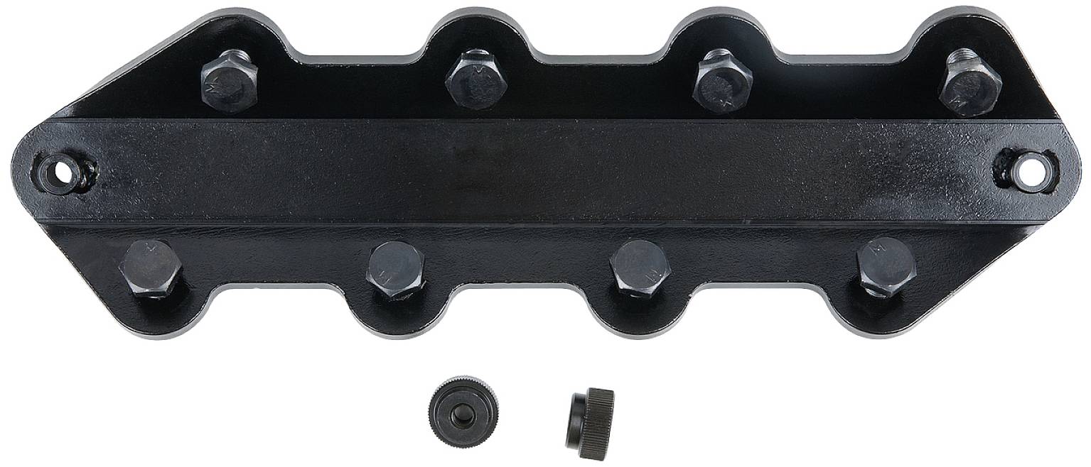 A black metal component with eight screw holes and a removable bung, likely a machine part or mounting bracket.