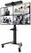 Video conferencing system with a camera mounted on top of a monitor stand. The screen displays four screens showing different groups of people in a virtual meeting.