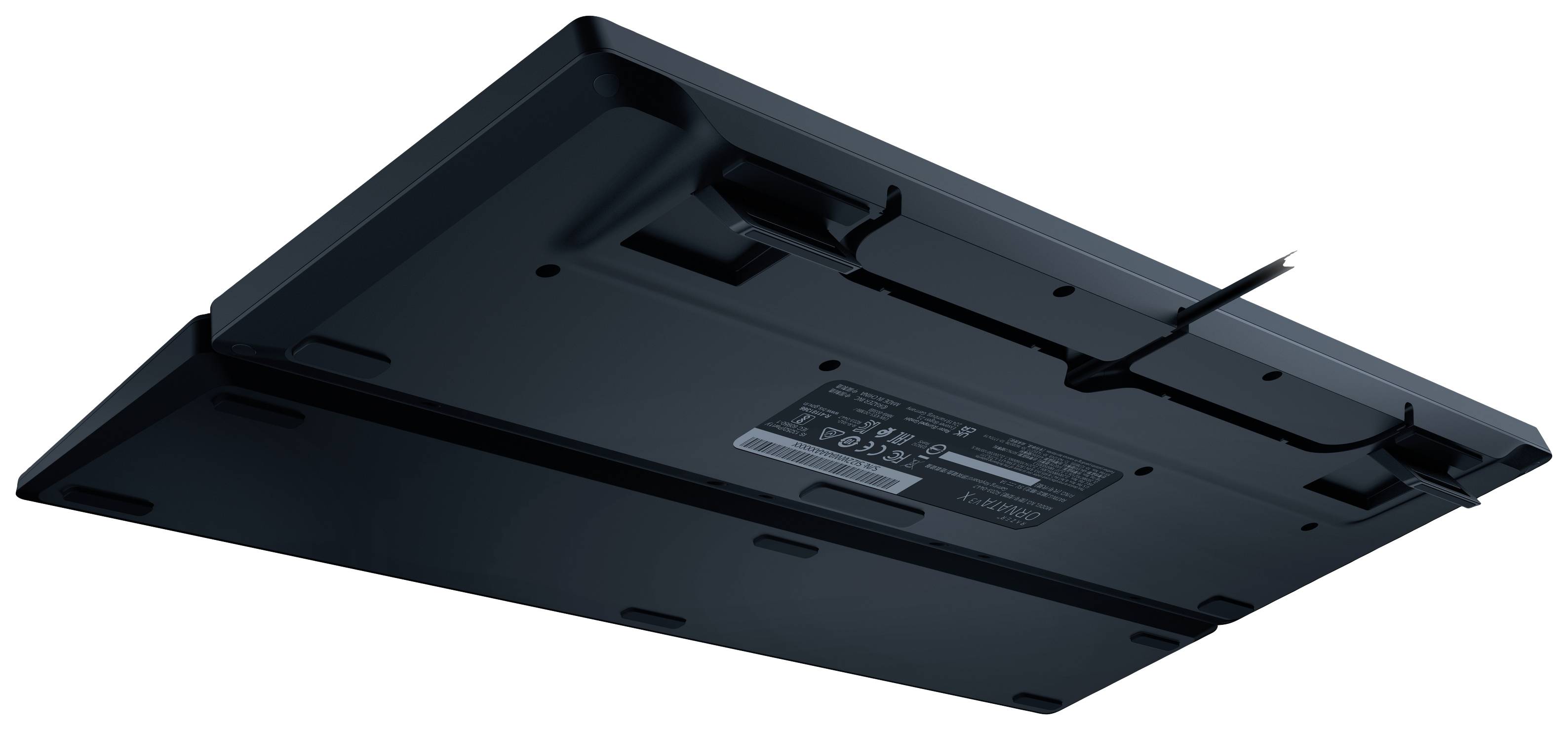 Black mechanical keyboard from below, showing cable management and rubber feet.