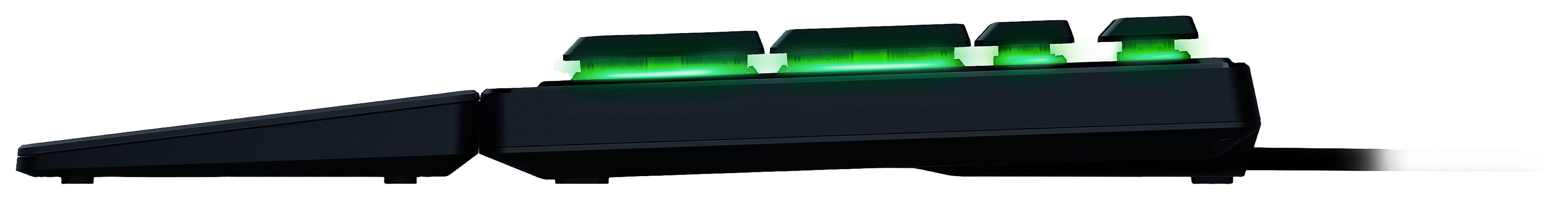 Side view of an angled, black computer keyboard with green backlighting underneath the keys.