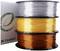 Three reels of coloured filament are stacked on top of each other: silver on top, gold in the middle, and copper at the bottom. A packaging with a logo is on the left.