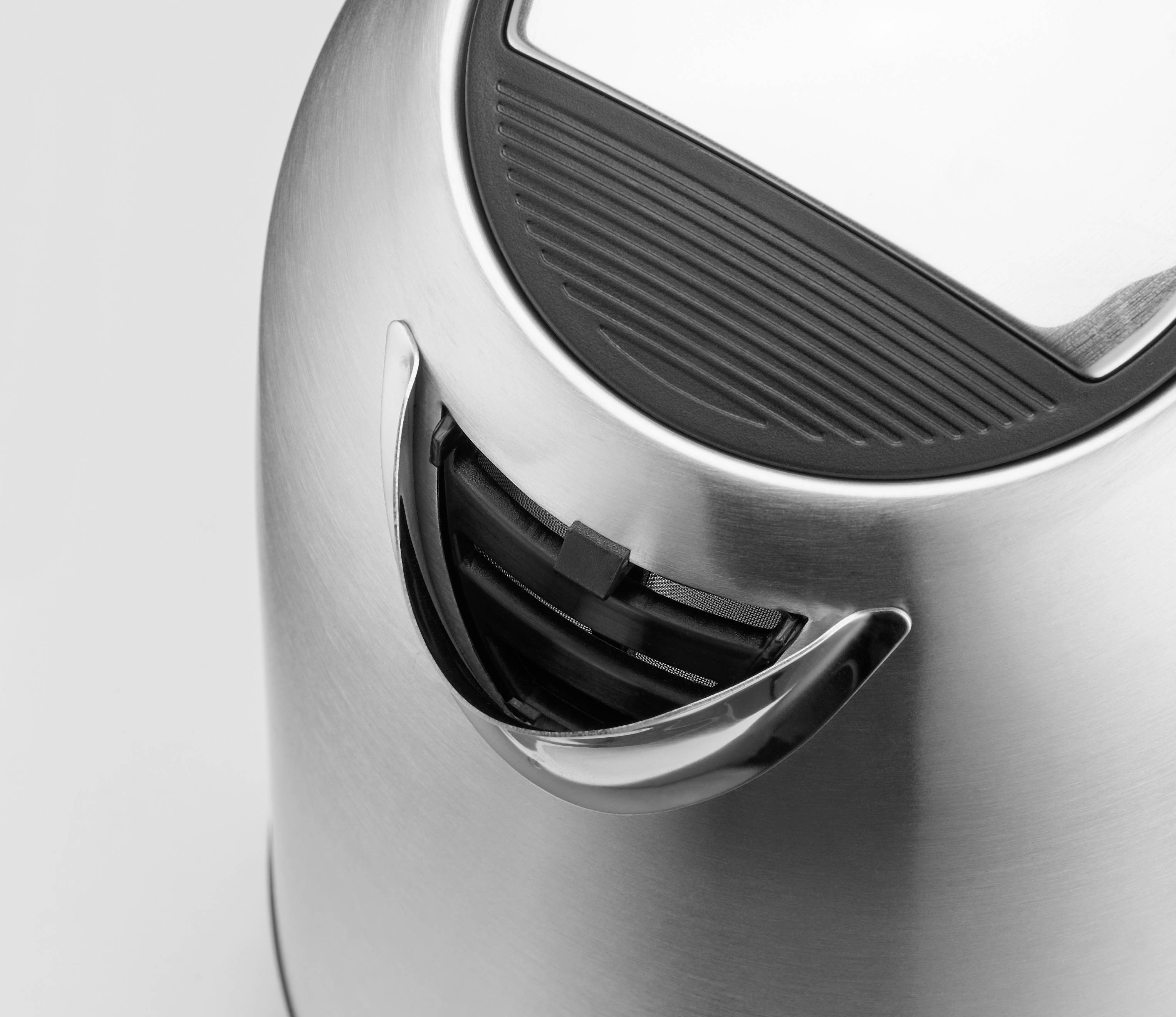 A modern, silver kettle with a black handle and lid, made of stainless steel, photographed from above.