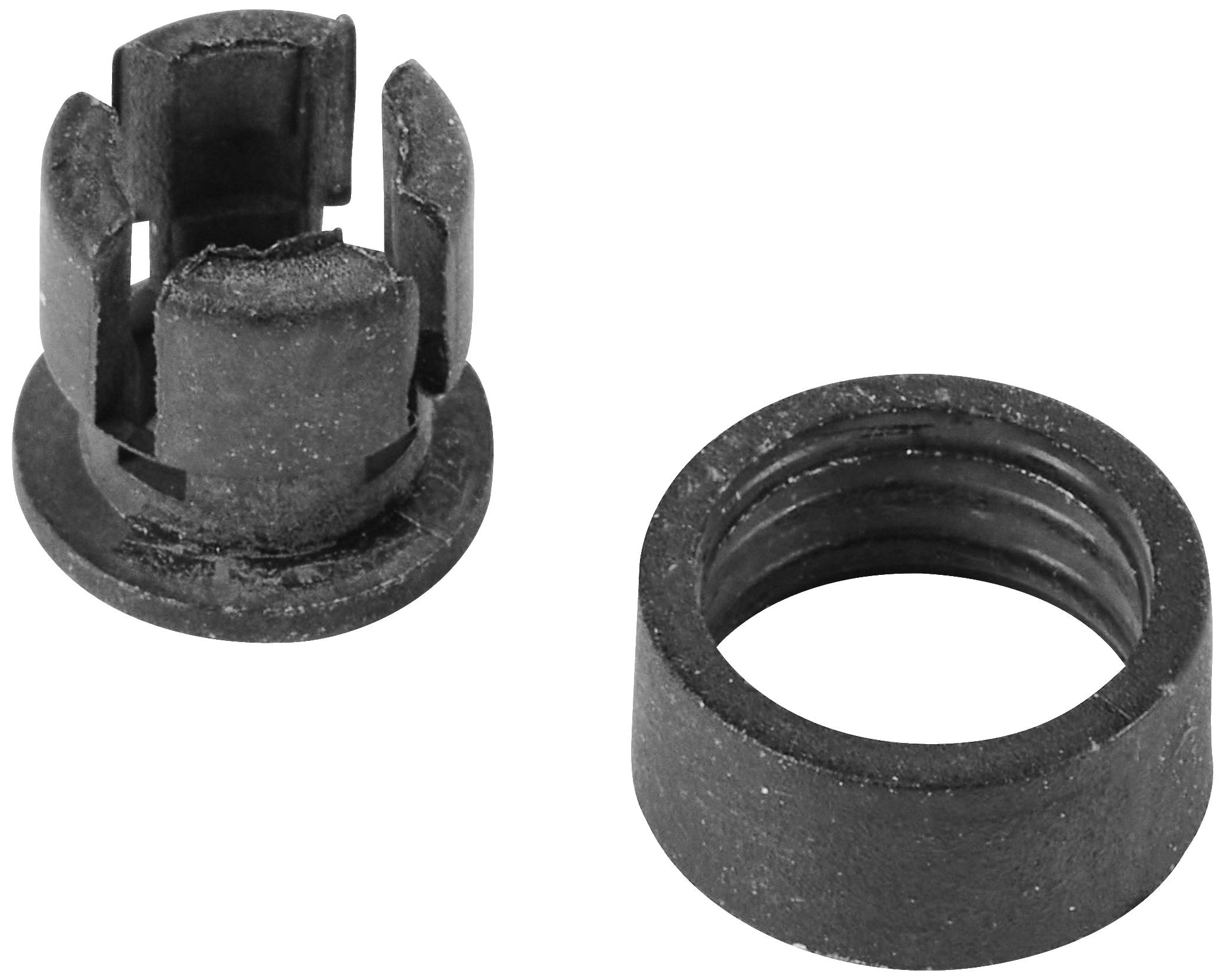 Two black metal components: on the left, a curved cap with slots, on the right, a ring-shaped adaptor. Used for mechanical connections.