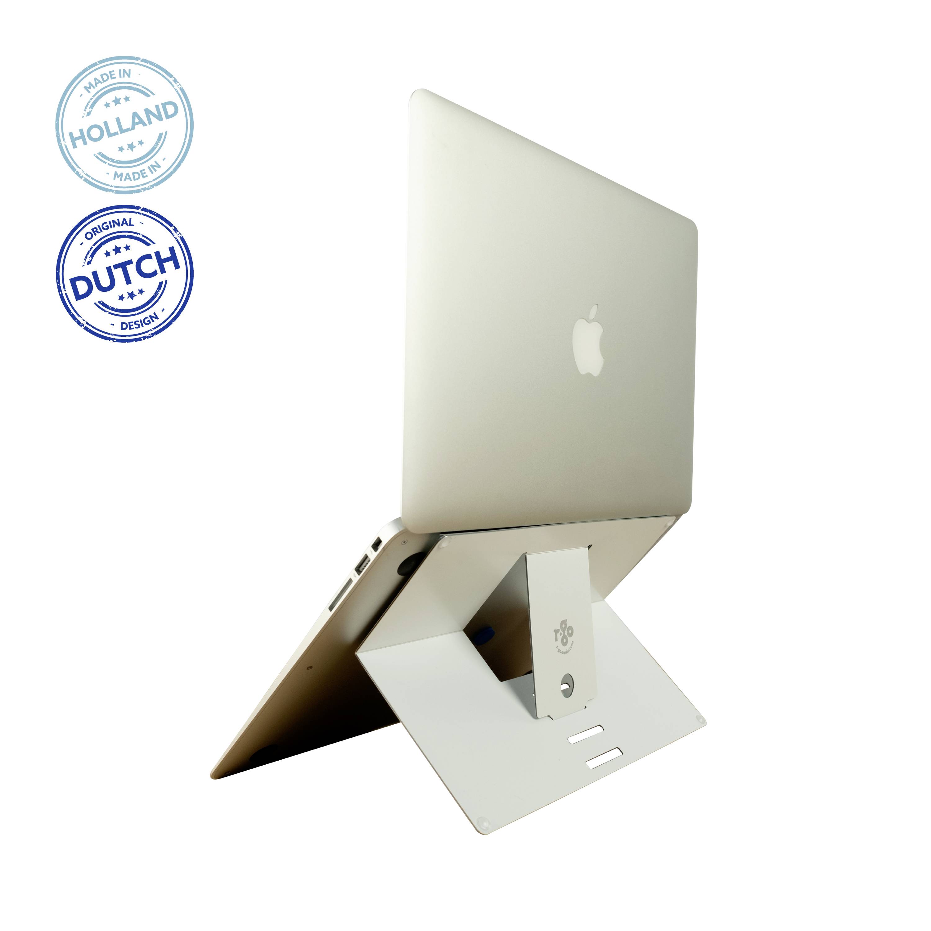 A laptop on a white stand, angled for ergonomic use. On the left are two blue seals reading 'Made in Holland' and 'Dutch Design'.