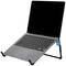A laptop is sitting on a black stand. The screen is switched off, and the keyboard is visible. The stand has a blue logo.
