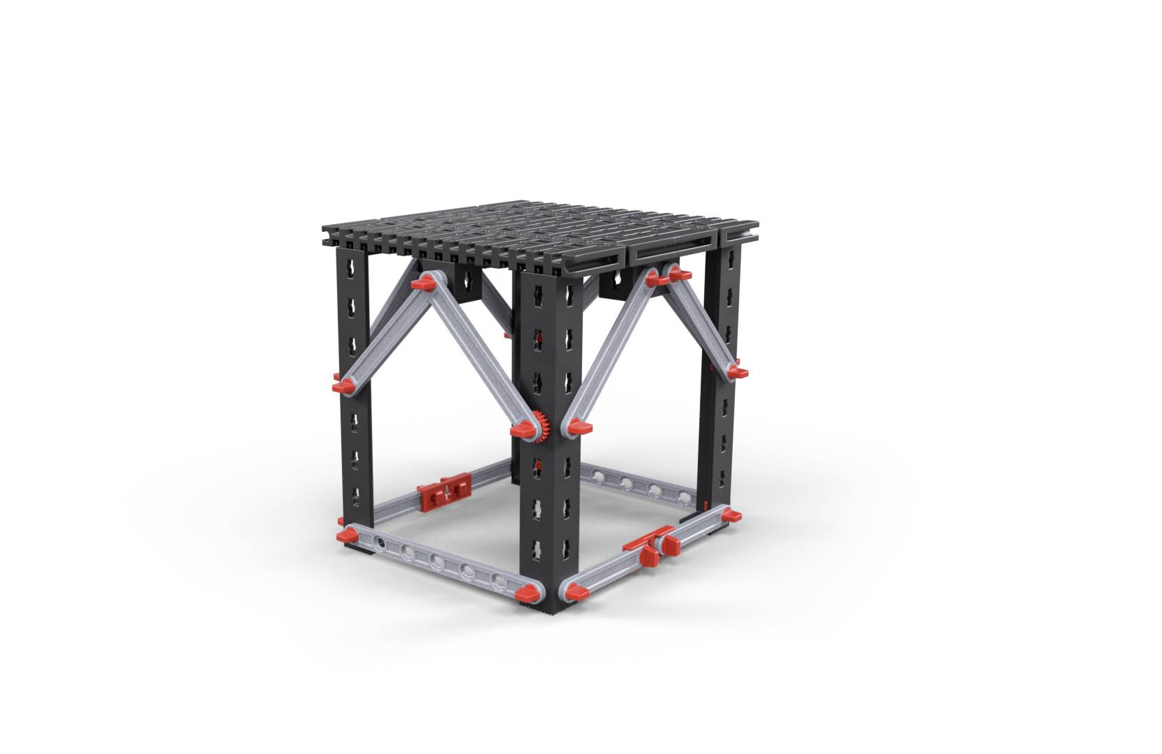 A cube made of metal struts and plastic panels with red connecting elements forms a stable, open structure.