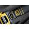 Close-up of a black and yellow power tool handle on a gray concrete surface, showing a power setting indicator and control knob.