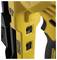 Close-up of a yellow power tool with two black switches in the central area. The tool is black and yellow and includes ergonomic details.