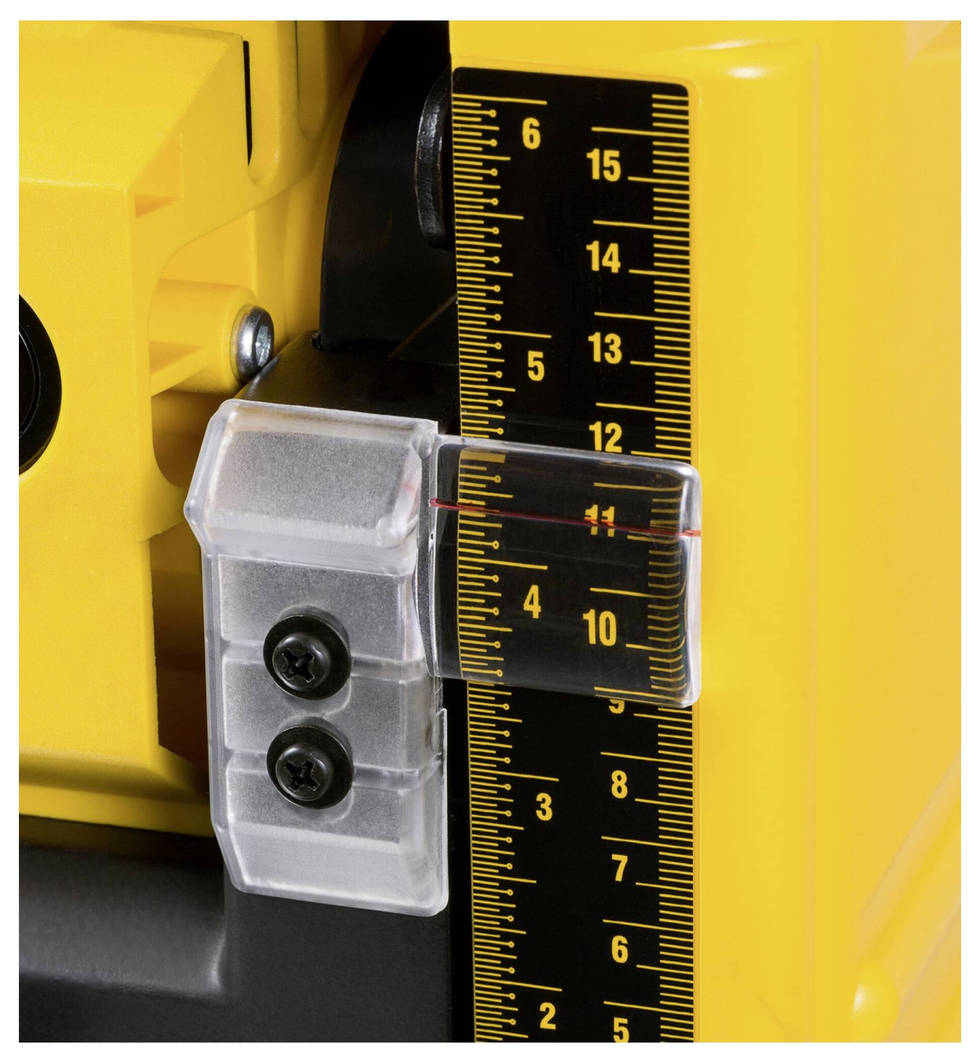 Close-up of a yellow device with a black, numbered ruler and transparent fixing mechanism. Reading at 11.