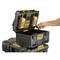 A person is placing two yellow battery chargers into an opened, black toolbox. The box is modular and stackable.