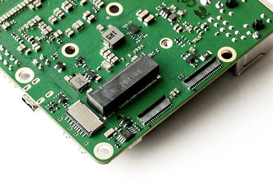 A green circuit board with multiple components, chips, and connectors, displayed on a white background.