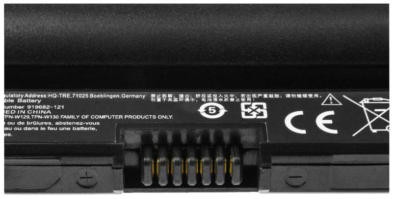 Black laptop battery with various safety and recycling symbols and contact terminals in the middle.