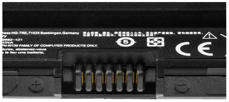 Laptop battery connector with various international safety symbols and manufacturing information on the reverse side.