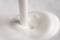 Milk is poured in a fluid motion, with a white, creamy texture.