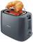 A grey Philips toaster, with a croissant being warmed on a roll attachment.