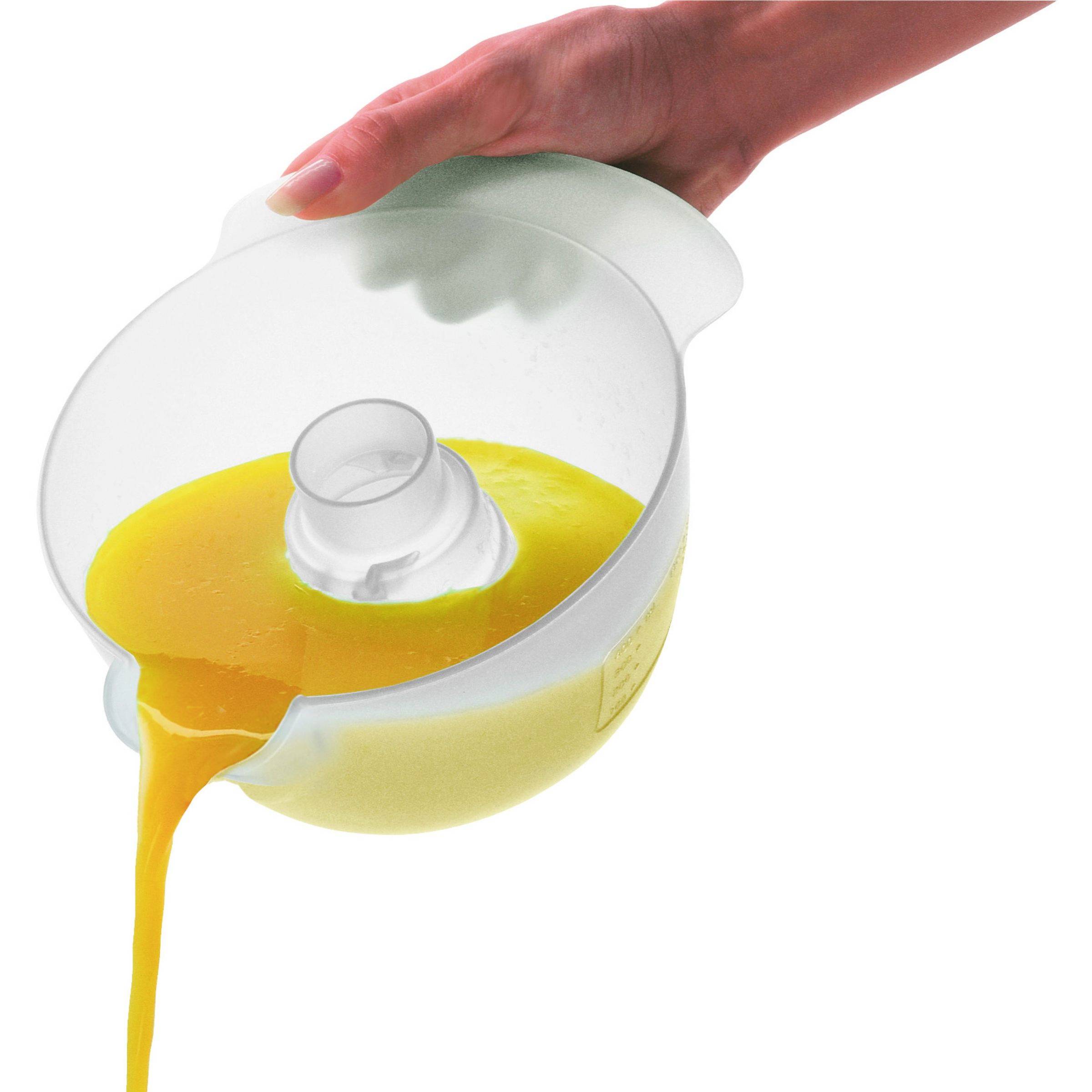 A hand is holding a transparent juicer, with freshly squeezed orange juice flowing into a container.