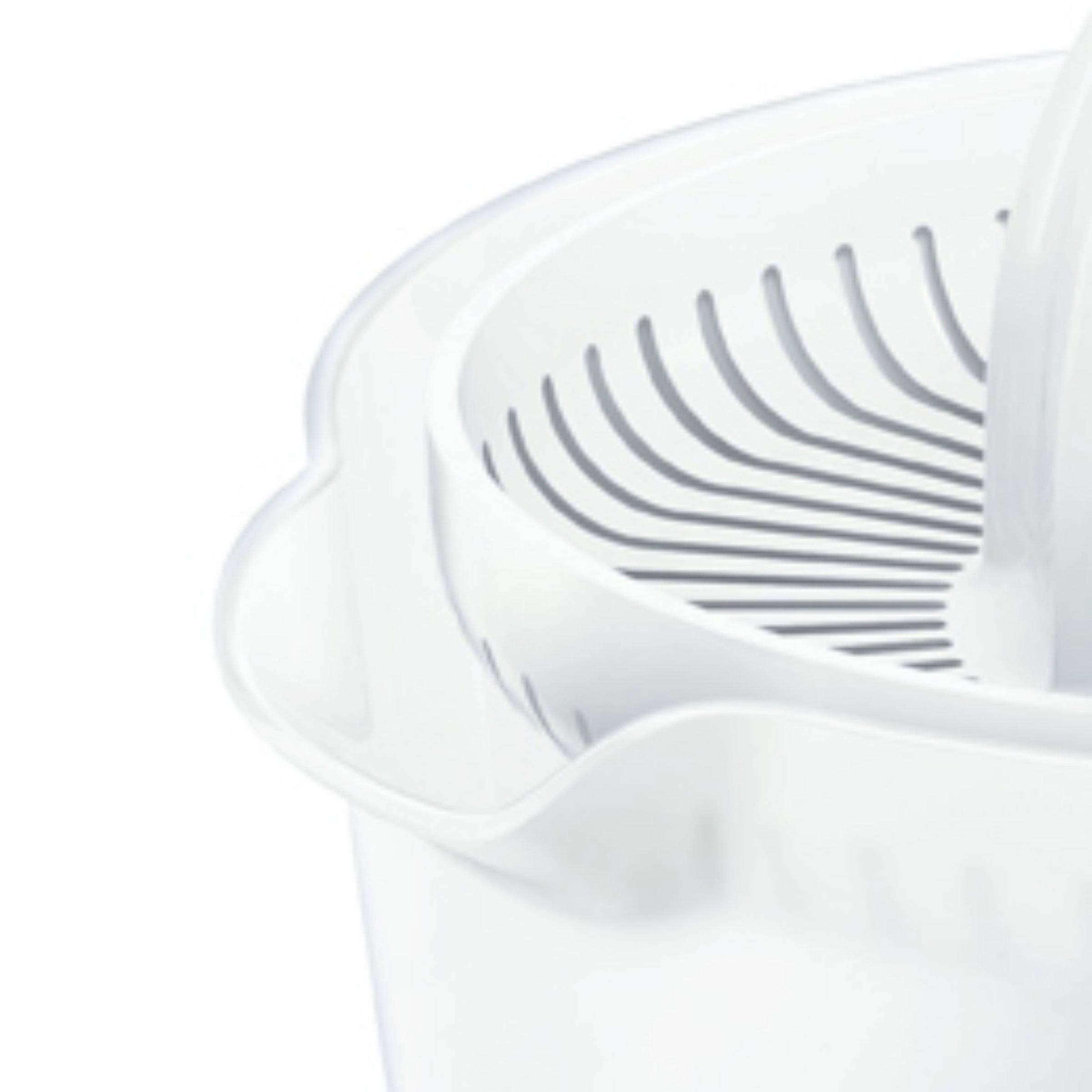 A white lemon squeezer with a ridged cone sitting over a bowl to catch the juice.