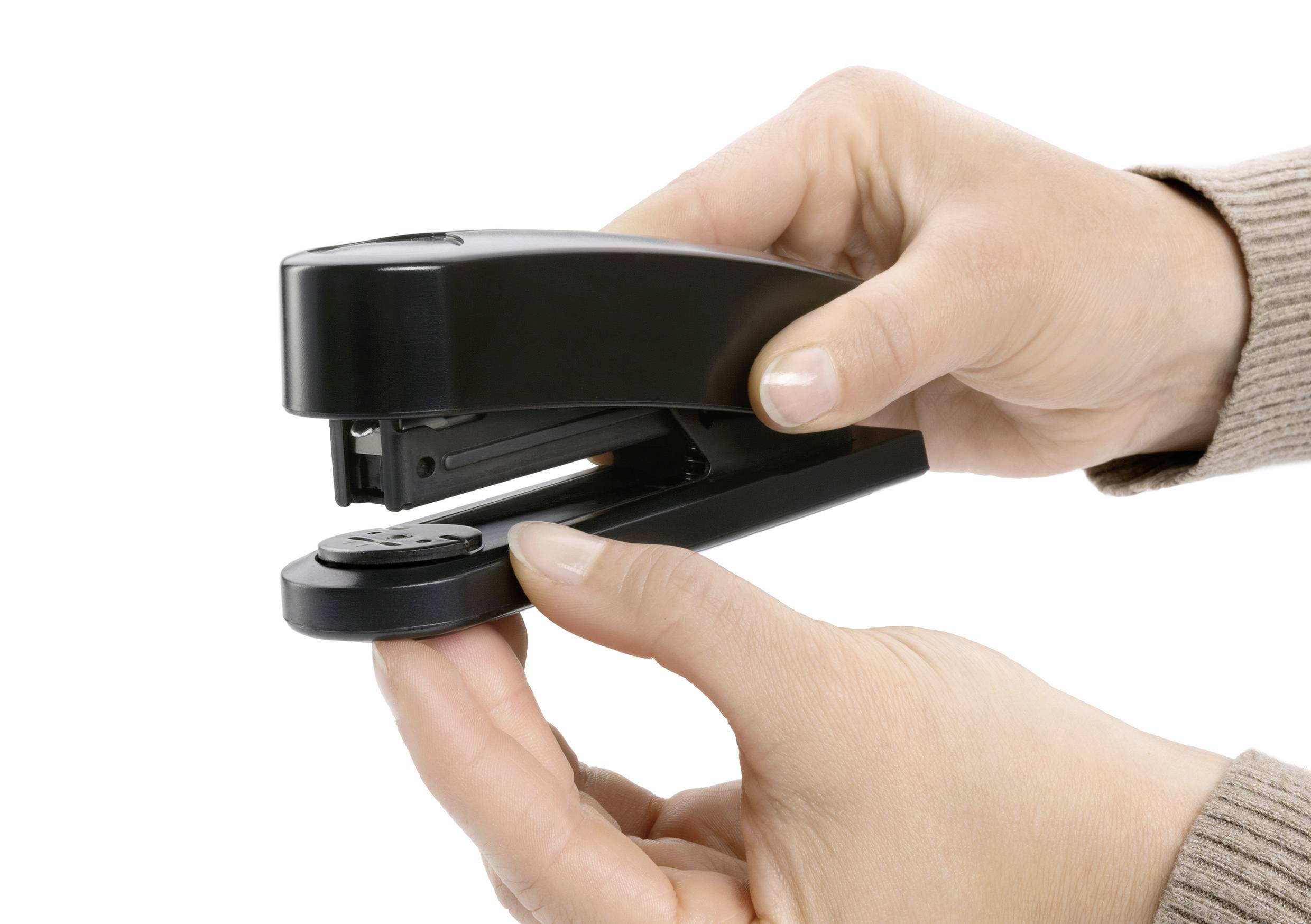 Two hands are holding a black ring binder, with one hand pressing it.