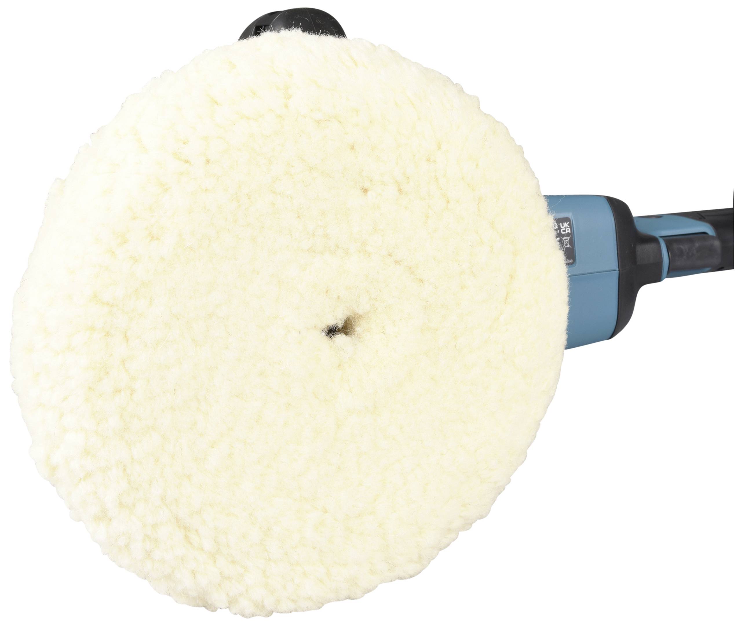 A circular, fluffy polishing pad on a blue electric polishing machine.