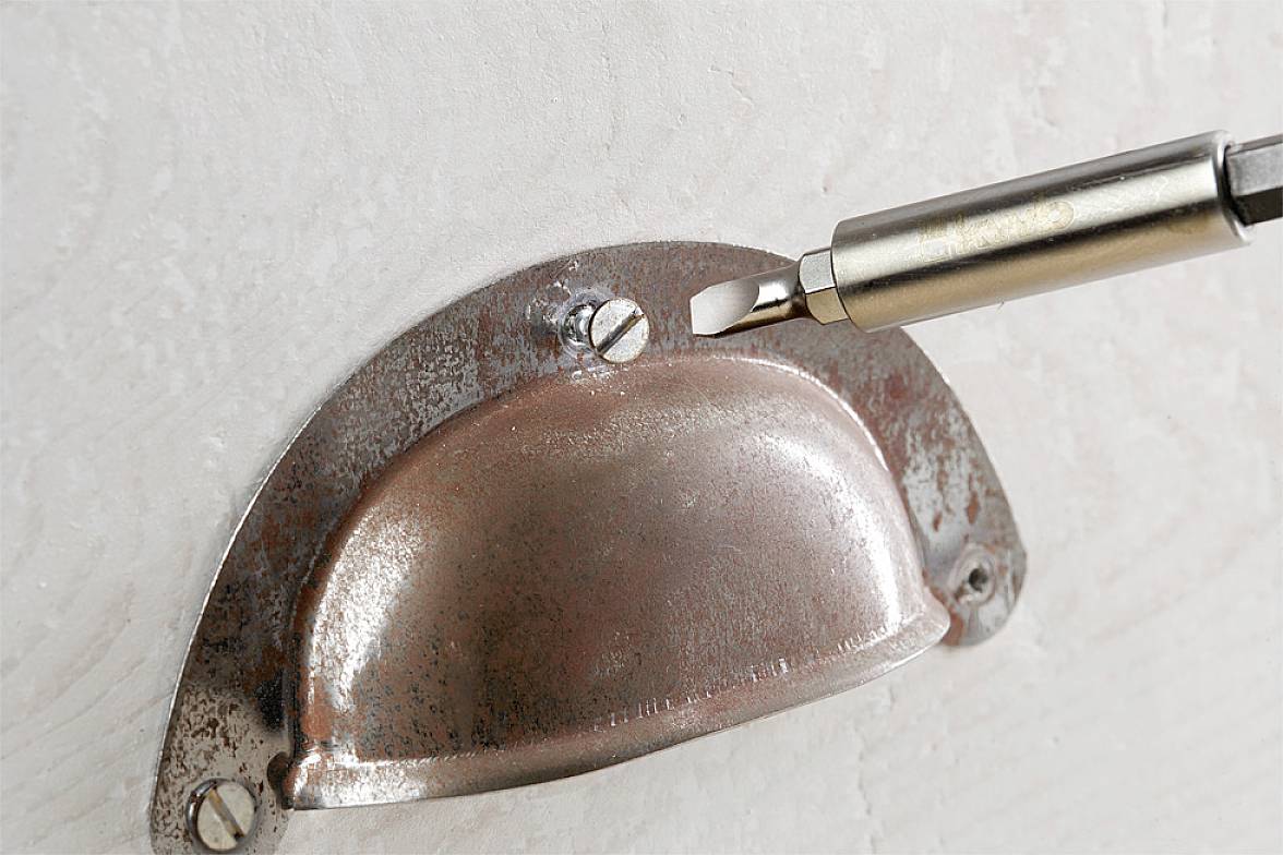'Silver drawer handle tray, secured with a screwdriver.'