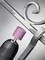 A drill with a pink polishing attachment buffs the surface of a curved metal handrail.