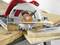 A circular saw cuts through several pieces of wood on a workbench. Sawdust is visible. Safety and precision in focus.