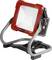 A red LED construction light with a sturdy metal stand, suitable for site illumination.