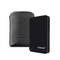 External hard drive in black design next to a black leather case. Brand name 'Intenso' on both. Suitable for data storage.