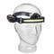 Translucent head torch with adjustable headband and light strip at the front, battery compartment on the side.