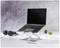 A laptop is placed on an adjustable-height stand on a desk, next to headphones and a small plant.