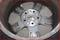 An aluminium alloy wheel with multiple spokes, shown from the inside. The surface is worn and shows light dirt or grime.