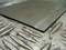 A thin sheet of metal is resting on a corrugated metal surface.