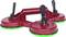 Red triple suction lifter with black handle and green rubber pads, used for lifting glass or smooth surfaces.