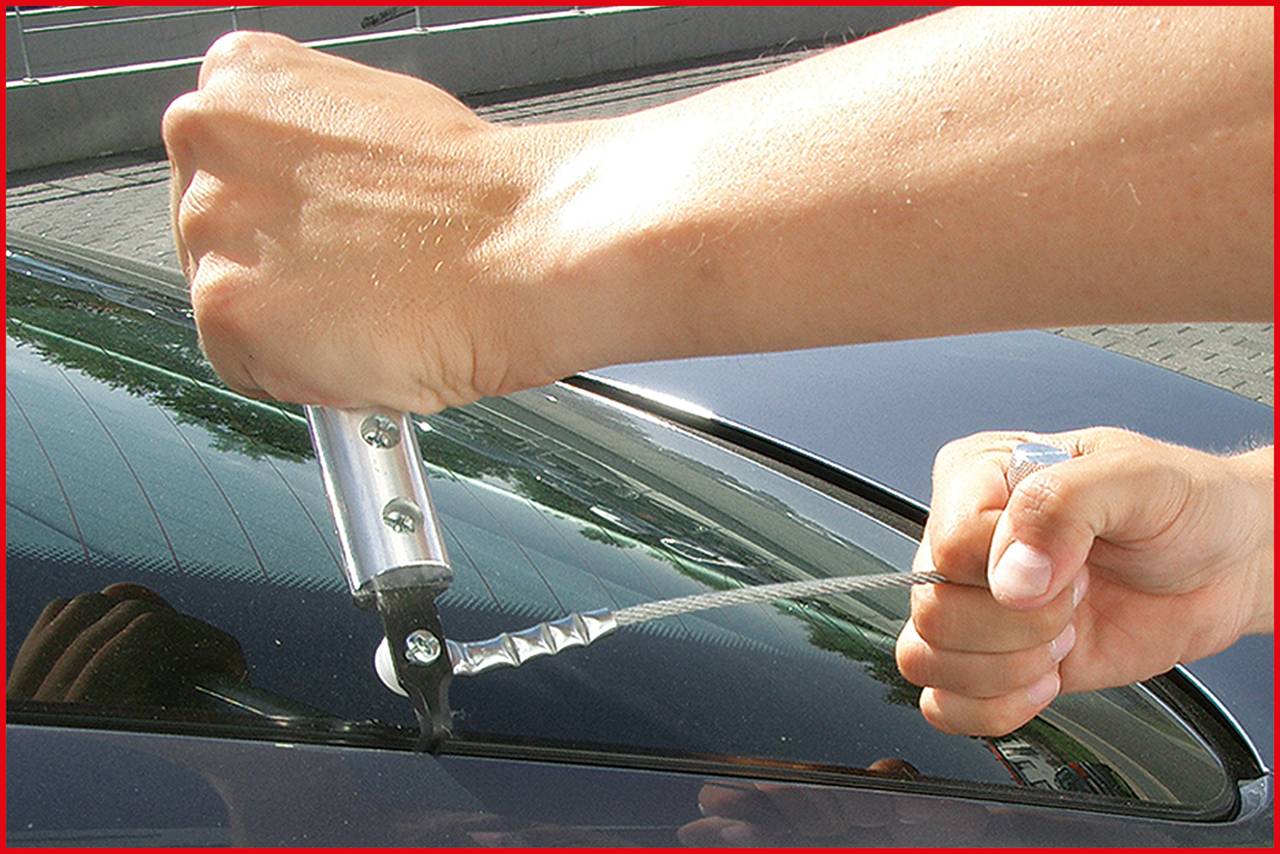 'Demonstration of the application of a suction grip tool on a car windscreen to facilitate the removal or lifting of the glass.'