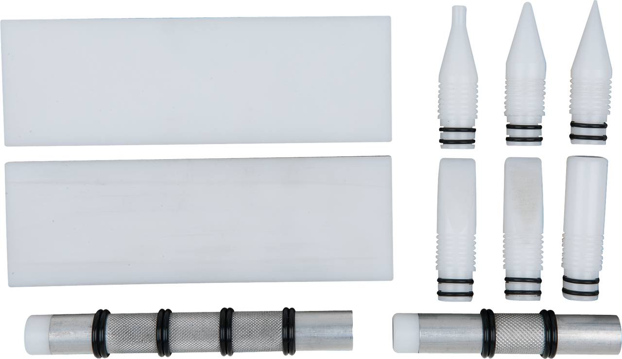 Various white and silver device elements and nozzles in different shapes and sizes, arranged side by side.