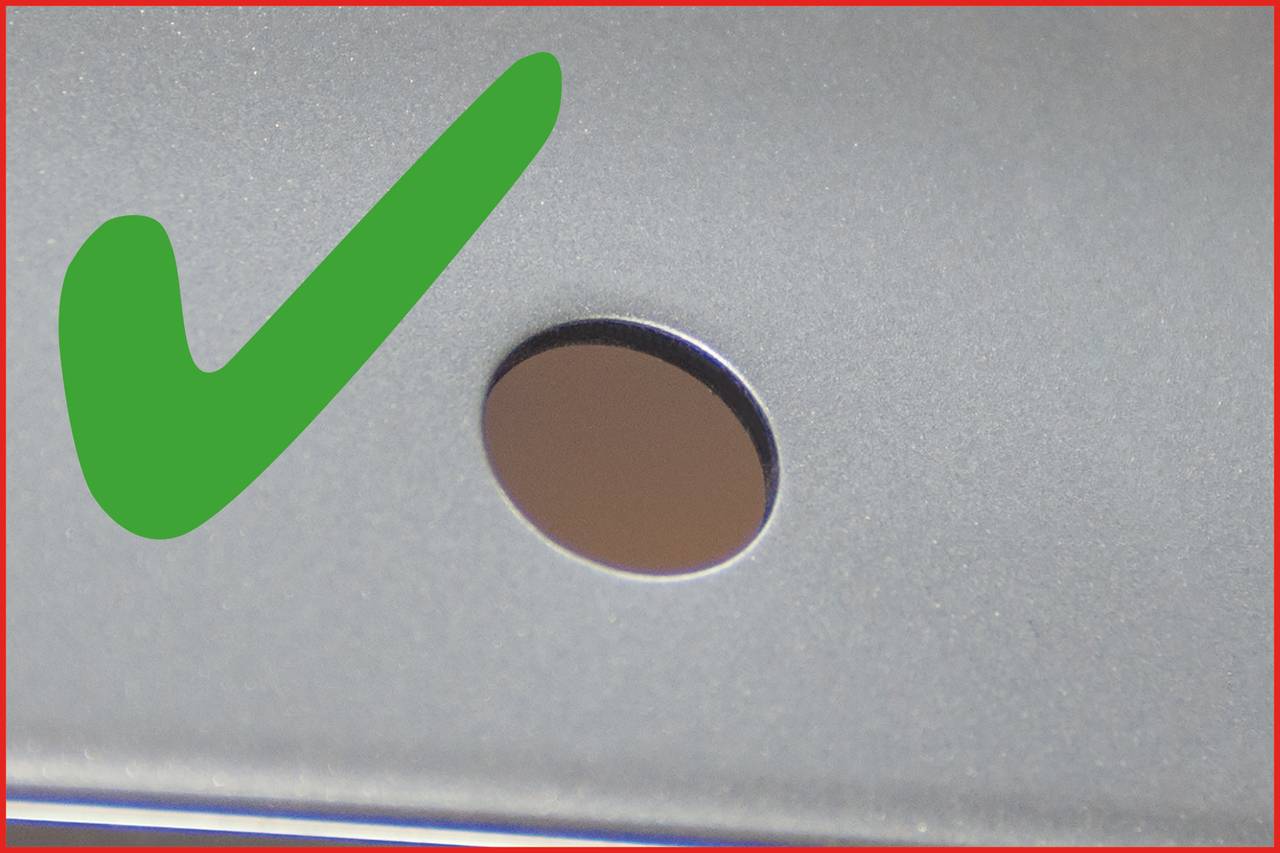 Green tick next to a round button on a grey surface. Theme: positive confirmation or correct selection.