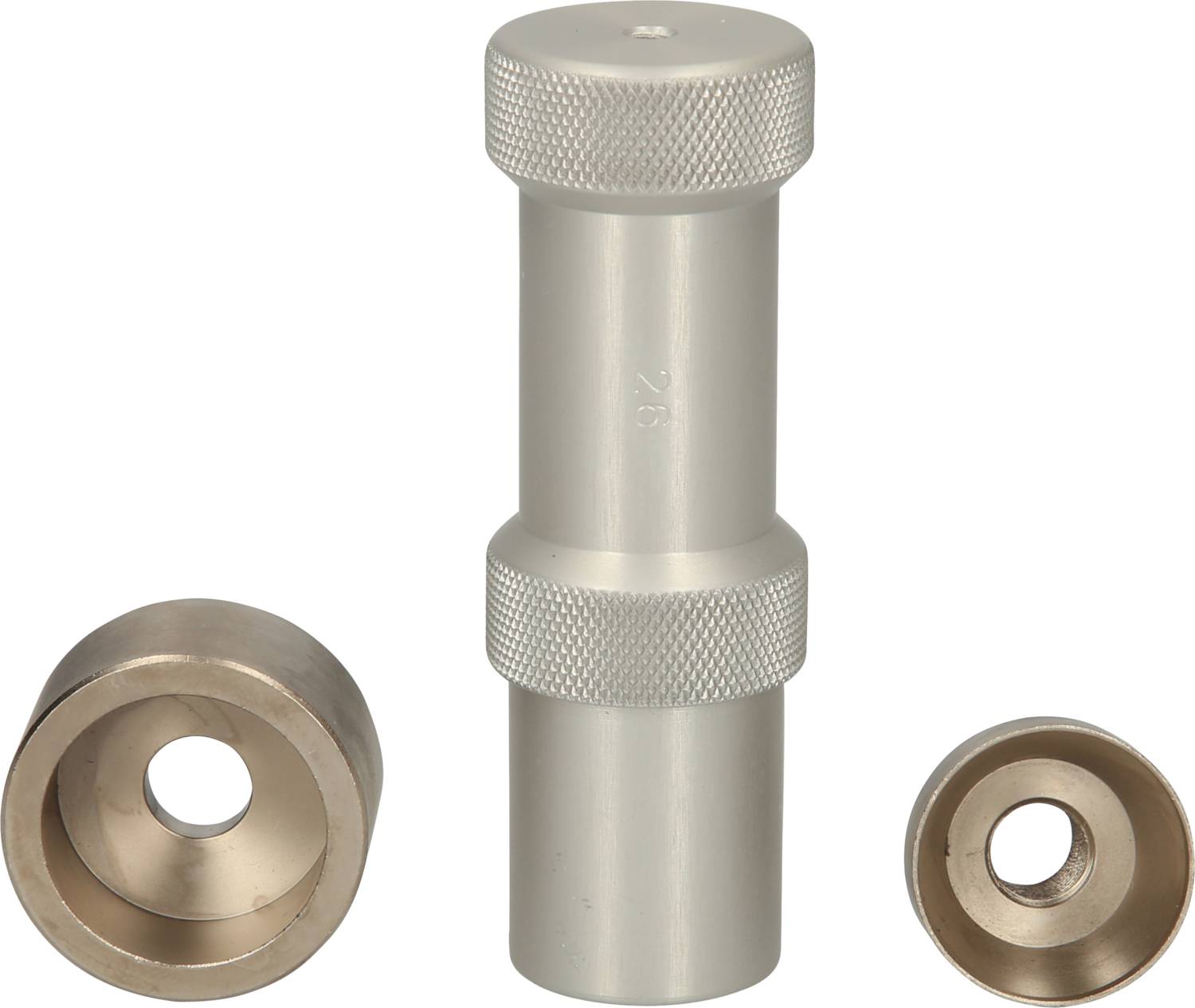 Metallic punching tool components with a cylindrical punch and two round dies, with the left one larger than the right.