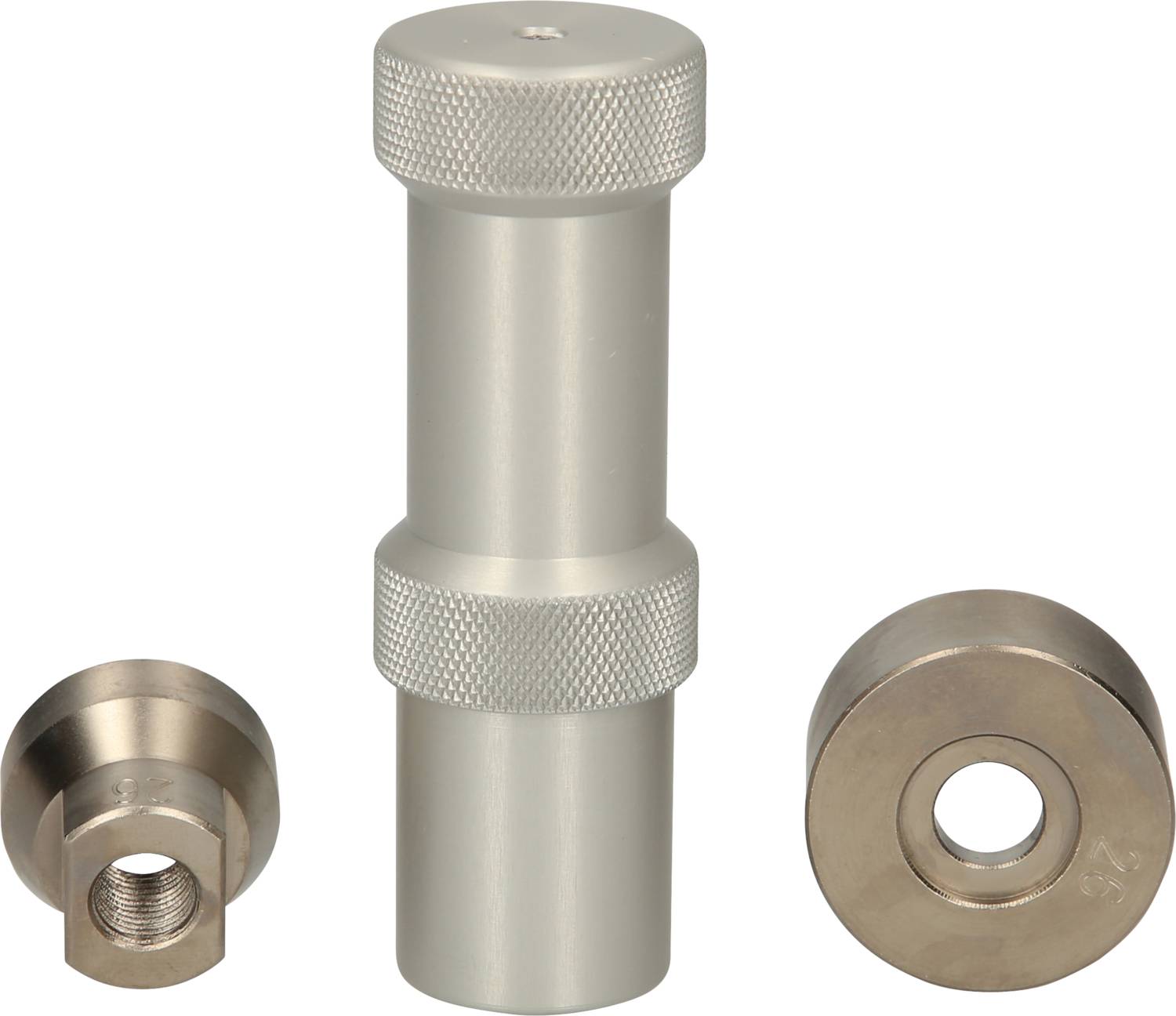 Three silver metal pieces, with an elongated object with a ridged surface in the centre, flanked by two round objects with holes.