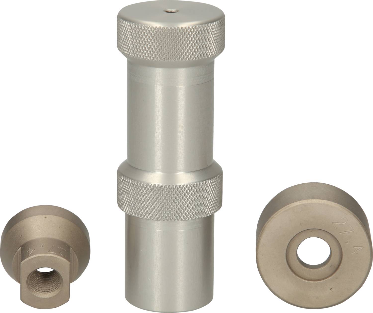 Three metallic tools: a cylindrical device in the centre with knurled edges and two round attachments on the left and right.