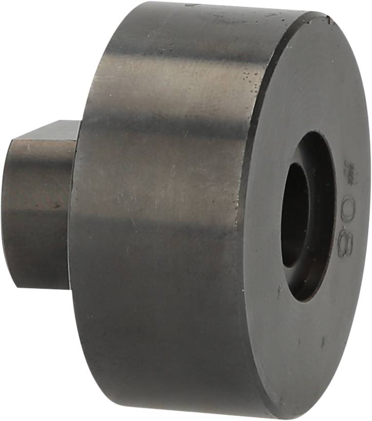 Metallic machine component in a cylindrical shape with a central opening and a square protrusion on the side.