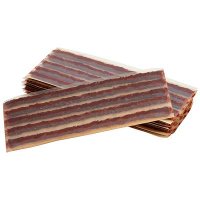 A stacked group of flat, rectangular meat snacks with dark brown stripes on a light base.