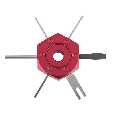 A hexagonal tool made of red metal with four protruding pins, used for adjusting electronic components.