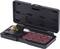 An open black case displays a set, consisting of a tool and several reddish-brown grinding discs, arranged in rows.