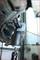 Mechanic's tool at work on a vehicle wheel. A puller is removing a ball joint pin from the suspension.