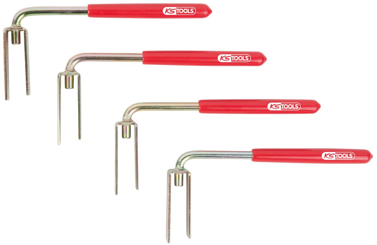 Four red scrapers of varying sizes with metal tips, arranged side by side, for use in the tool area.