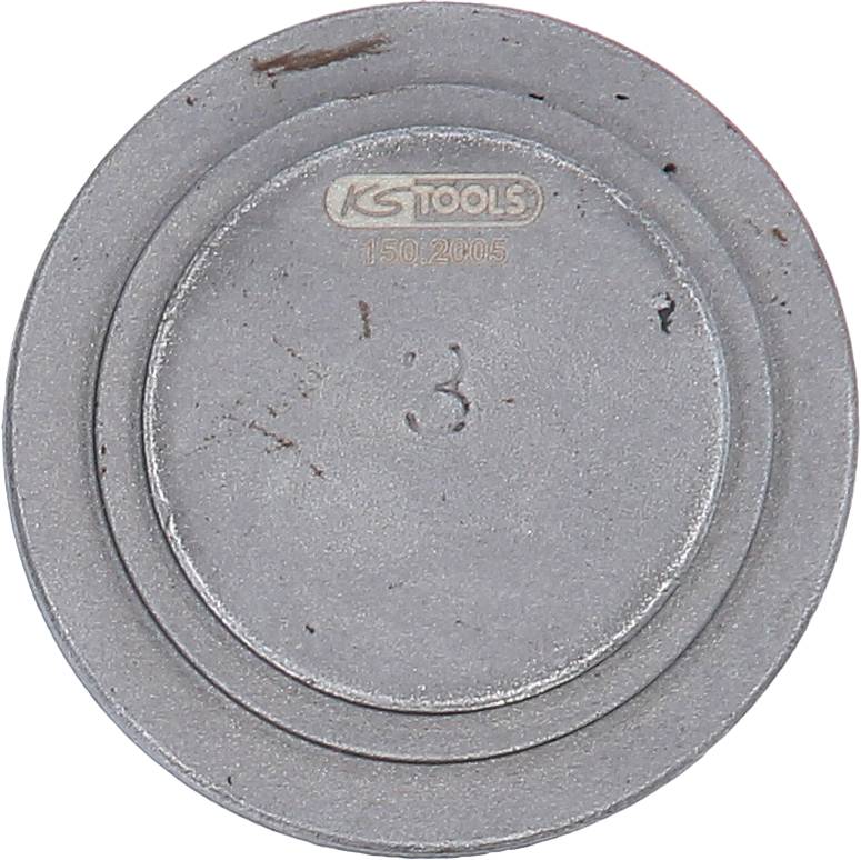 A round, metallic workshop object with the inscription 'KS TOOLS 150.2105' and the number '3' in the centre.