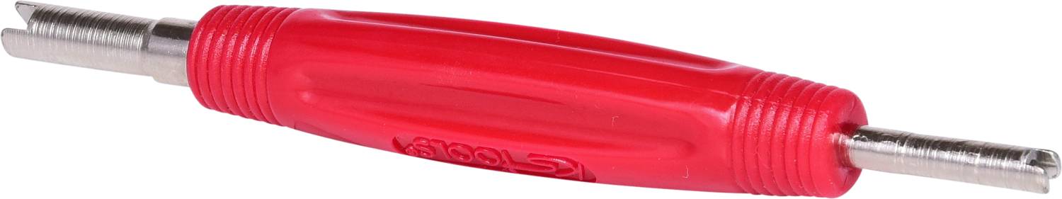 Red tool with two metal points, used for cutting or aligning threads in pipes.<br><br>Corrected British English translation:<br>Red tool with two metal points, used for cutting or aligning threads in pipework.