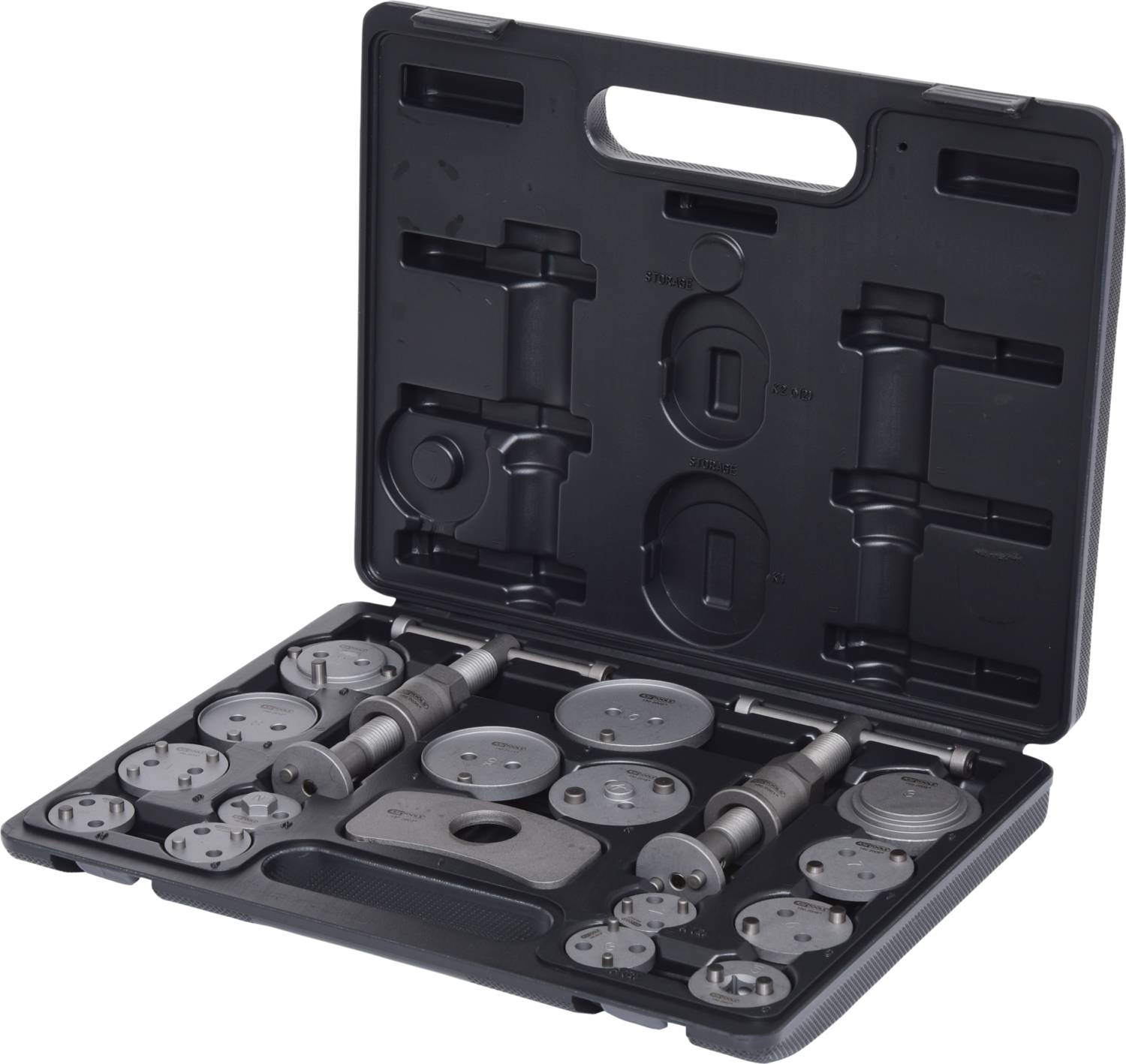 A open toolbox with various round brake calliper pistons and tools in compartments, ready for repair.